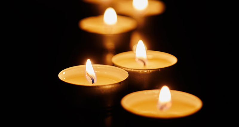 Burning votive candles on dark background - Jillian Frazin - Blessings of Jasmine